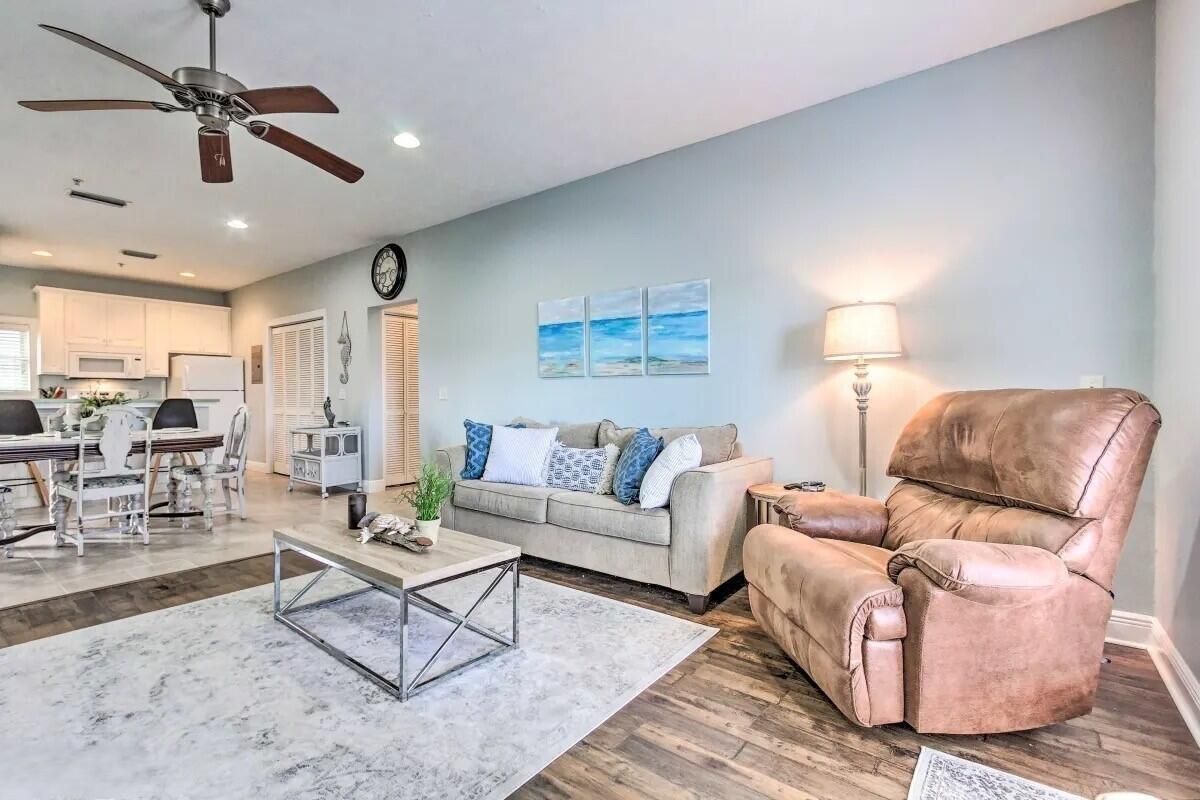 A modern living room with a sofa, a coffee table, and a leather recliner.