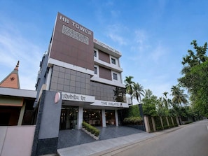 A hotel with a sign reading 'HB Tower' and 'MIDTOWN IMPEX'. - Super Deluxe Room Hotel Midtown Inn (Guwahati)