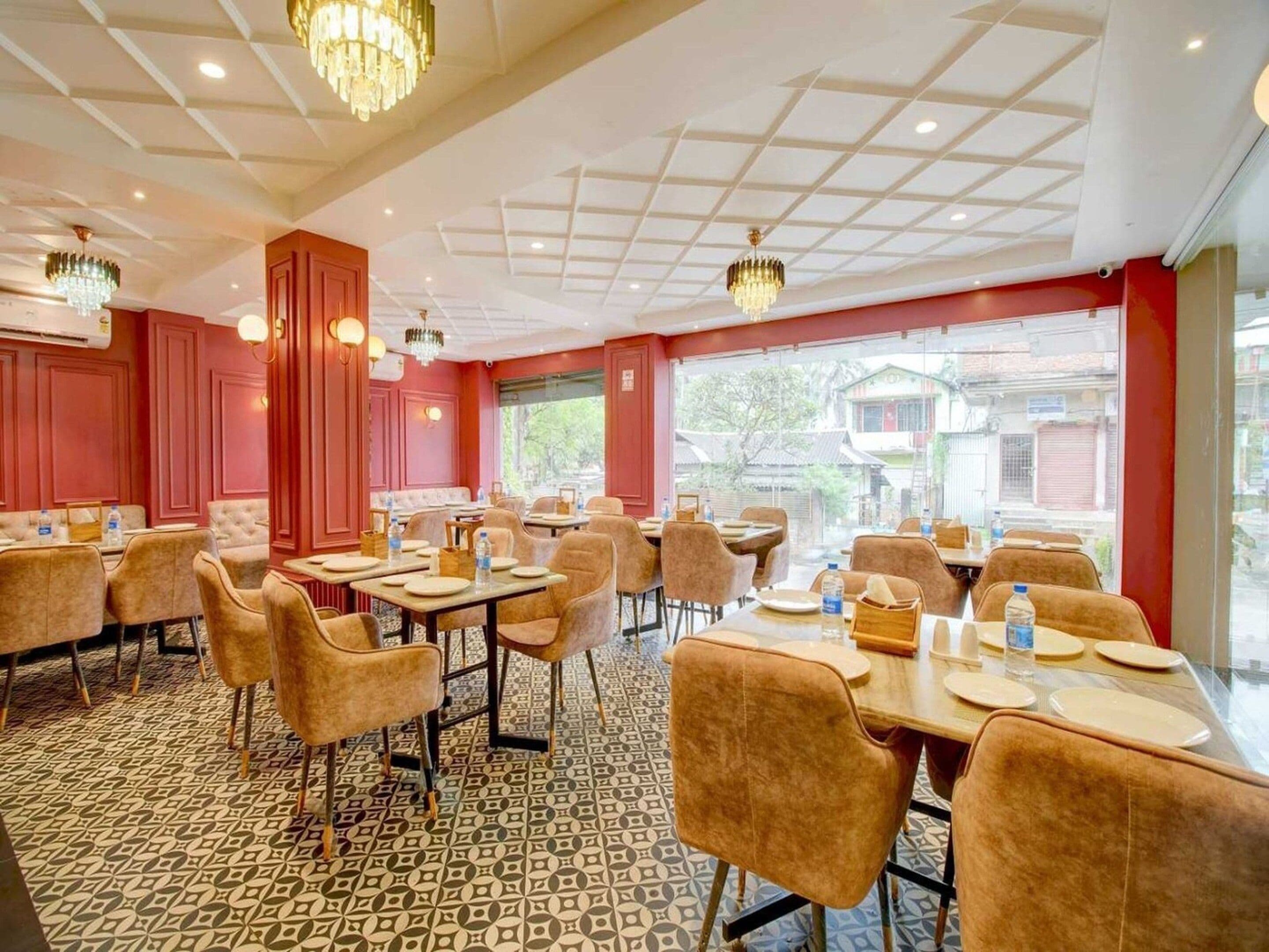 A dining area with tables and chairs, a patterned floor, and a view through the window.