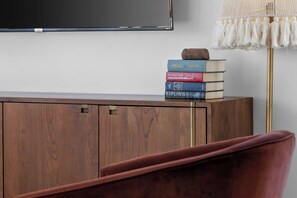 A wooden cabinet with a stack of books and a lamp. - Hot Tub Hang Grill Parking  Views of Downtown (Nashville)