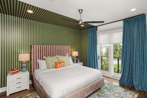 A bedroom with a bed, nightstands, a ceiling fan, and a view through a glass door. - 8 Beds | Minutes to Broadway, Gulch & 12 South (Nashville)