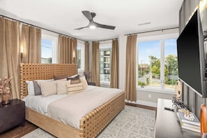A modern bedroom with a large bed, a ceiling fan, and a TV. - Luxe Retreats Sleeps 24: Games, Views, Near Dwntwn (Nashville)