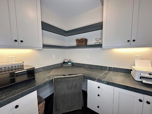 A kitchen with white cabinets, a granite countertop, and a built-in oven. - Luxury Franklin Farmhouse (Franklin)
