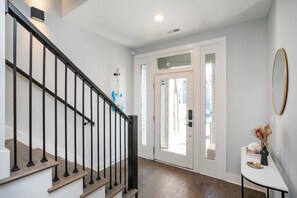 A staircase with black railings leading to a door with a glass panel. - 1 Mile to Downtown 4BR w/Rooftop (Nashville)