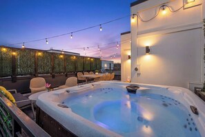A rooftop terrace with a hot tub, string lights, and outdoor seating. - 2 Homes | 24 Guests | Rooftop Hot Tub Fire Pit (Nashville)
