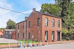 A two-story brick building with a flat roof and a small porch. - The Adams Suite | Germantown Inn | Breakfast (Nashville)