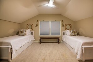A bedroom with two single beds, a bench, and a ceiling fan. - 65Acres HotTub, Sauna, Cold Plunge, Fishing + Golf (Joelton)