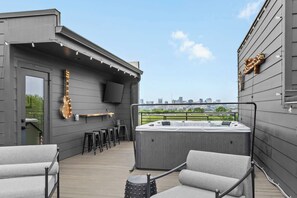 A rooftop terrace with a hot tub, seating area, and a city view. - Rooftop Oasis - Hot Tub, Nashville City Views (Nashville)