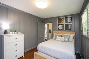 A bedroom with a bed, dresser, and wall art. - Yard, Parking, 4.5 Mi to Bway (Nashville)
