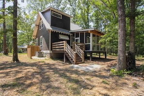 A cabin with a wooden exterior, a staircase, and a deck. - Purple Martin and The Cardinal at Buckhorn Hollow (McEwen)