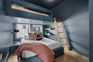 A bedroom with a bunk bed, a window, a ladder, and a shelf with decorative items. - Sleeps 24  2 Homes City Views  Hot Tub Fire Pit (Nashville)
