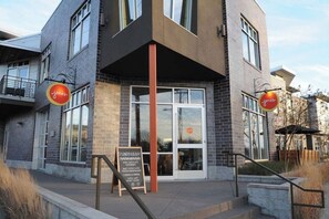 A modern building with a storefront, large windows, and a sign that reads 'Splendid Holiday.' - East Nash Cottage 3 Miles to Downtown! (Nashville)