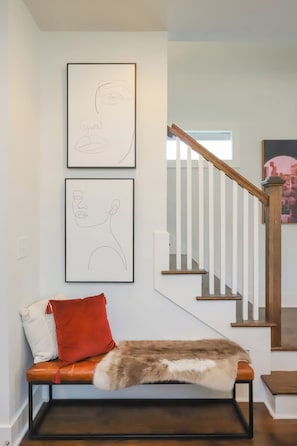 A staircase with wooden steps and white railings, leading to an upper floor. - Walk to 12 South & 8th Ave! 4BR/4BA (Nashville)