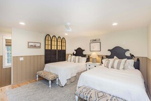 A bedroom with two beds, a bench, a window, and a wall-mounted artwork. - The Covey: Luxury Woodland Farm Retreat (McEwen)