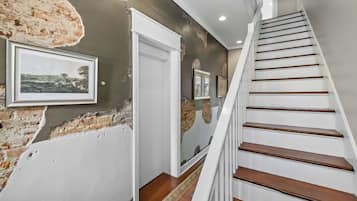 A staircase with white railings and wooden steps leading to a door with a white frame.