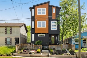 A modern two-story building with a black and brown facade, numbered 216. - Sanctuary + Hot Tub + Outdoor Haven (Nashville)