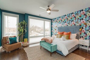 A bedroom with a bed, a nightstand, a window, a ceiling fan, and a potted plant. - Near Broadway - Walk to Geodis Park + WeHo (Nashville)