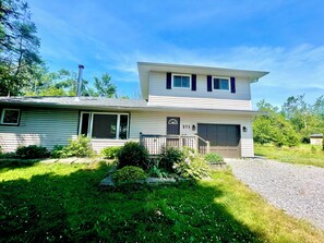 A two-story house with a garage, number 271, surrounded by greenery. - Dual Purpose Comfort: 4BR Park & Beach House + Office & High Speed WiFi (Kawartha Lakes)