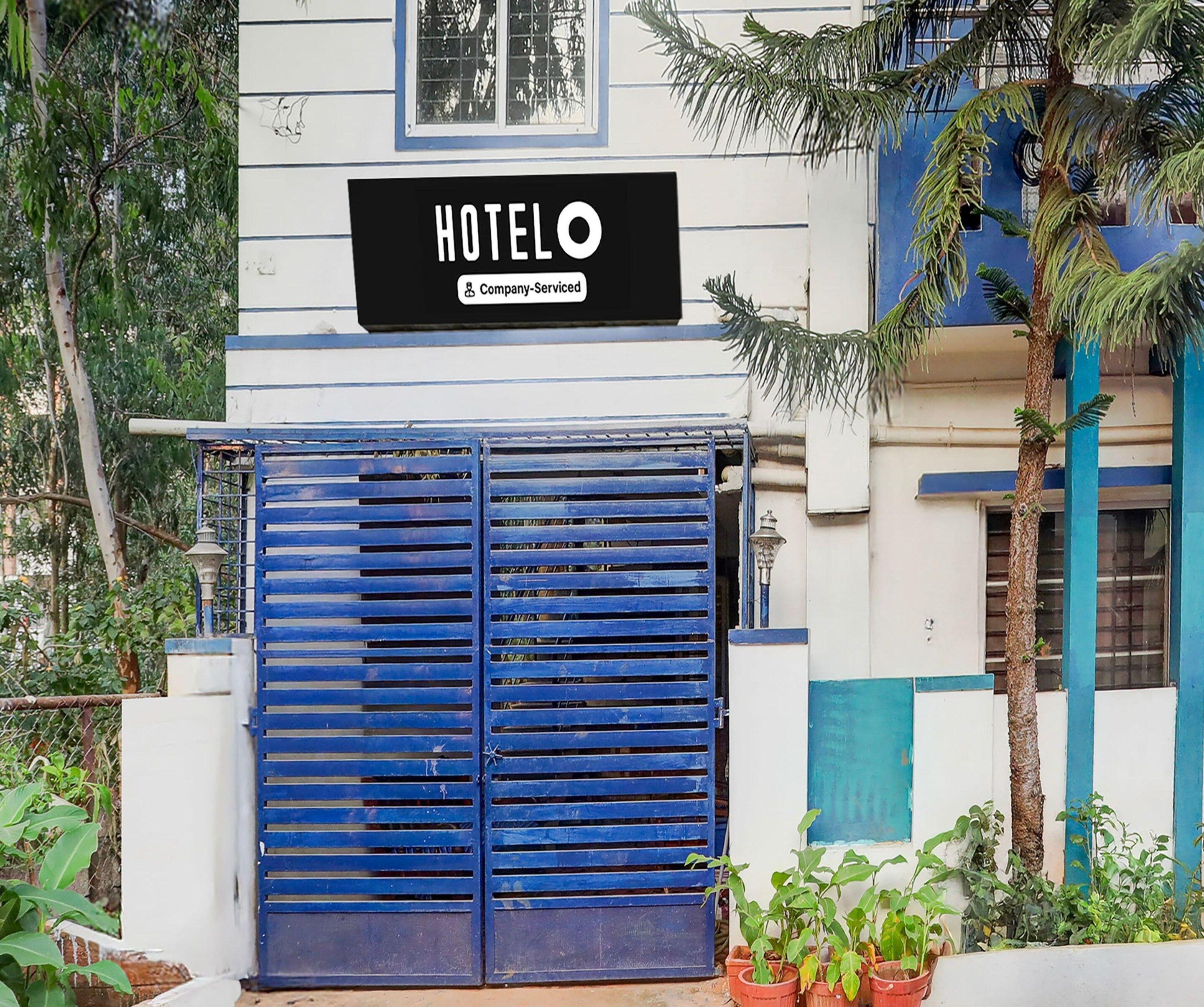 A hotel entrance with a sign that reads 'HOTEL & Company Serviced'.