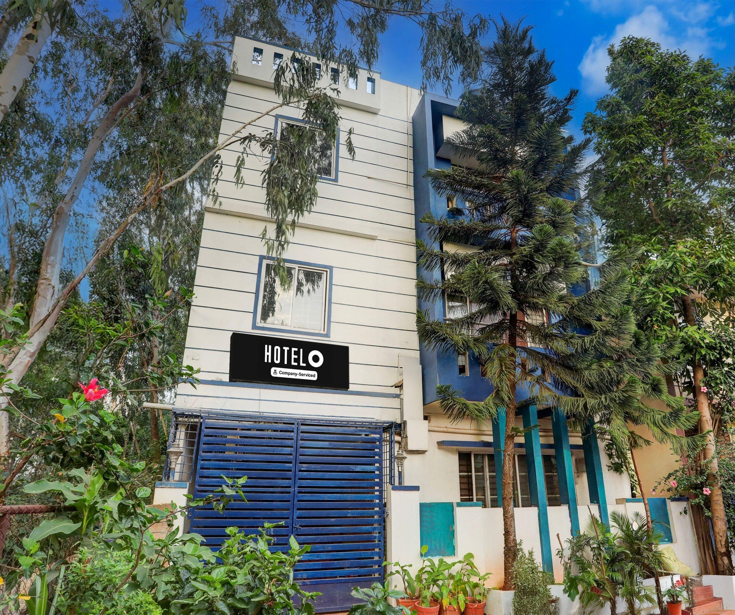 A hotel building with a sign indicating it is a company-serviced hotel.