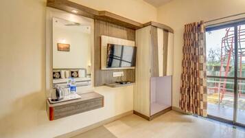 A modern bathroom with a vanity, mirror, and a television mounted on the wall.