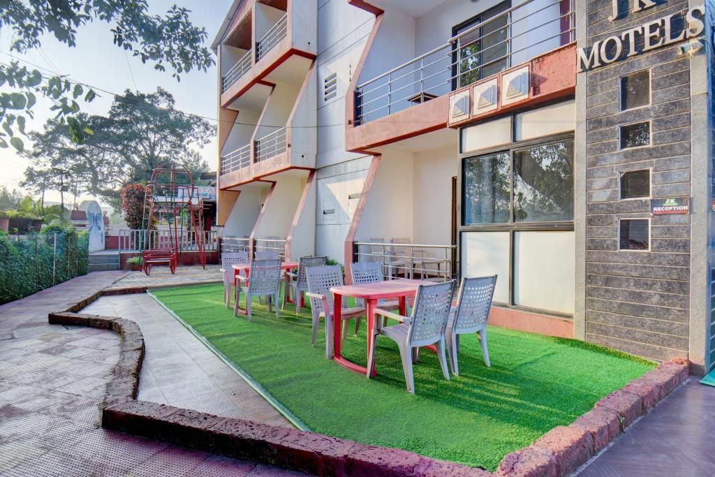 A motel with outdoor seating and a reception area.