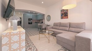 A modern living room with a grey sofa, a glass coffee table, and a patterned rug. - Stay at Ruby's Boutique townhouse for 6– 3 terraces, 4 min walk to the beach (Fuseta)