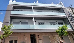 A multi-story building with a flat facade, balconies, and a central entrance. - Ondas Beach House
Designed for your natural living a few steps from the beach (Monte Gordo)