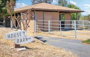 A rural property with a house and barn, a metal gate, and a directional sign. - Hillview Ranch Retreat A/C Views 16+ guests (Fallbrook)