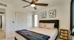 A bedroom with a bed, a ceiling fan, a window, and two wall-mounted pictures. - Private Pool Oasis | Near Tempe Diablo Stadium (Phoenix)