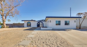 A single-story house with a front entrance, a small porch, and a driveway leading to the garage. - Private Pool Oasis | Near Tempe Diablo Stadium (Phoenix)