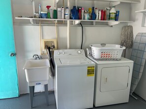 Ein Waschraum mit Waschmaschine, Trockner und Spüle.