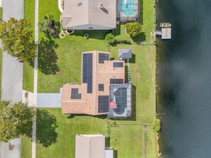 A residential property with a large house, a swimming pool, and a dock. - Private Pool + Bar - Pet Friendly - Sleeps 6 (Port Orange)