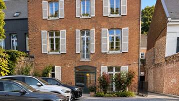 A brick building with multiple windows and a gated entrance.