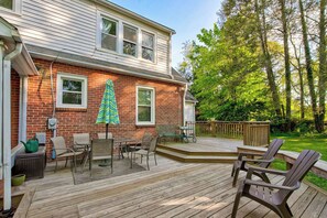 A two-story house with a deck, outdoor furniture, and a Christmas tree. - *Charming* 3bd dog-friendly entire Home close to DT (Winston-Salem)
