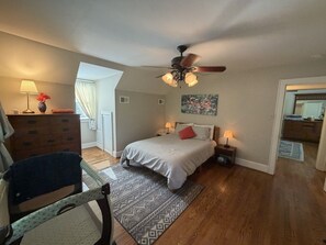 A bedroom with a bed, bedside lamps, a ceiling fan, a dresser, and a chair. - *Charming* 3bd dog-friendly entire Home close to DT (Winston-Salem)