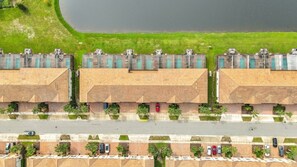 A multi-story parking structure with a central road and a grassy area in the background. - Disney 5BR Home, Private Pool, Water Slides (Kissimmee)