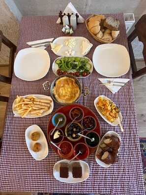 A table set with various dishes including bread, cheese, and olives.