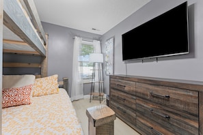 A bedroom with a bed, a dresser, a TV, and a window with curtains. - Huge Table Rock Lake Views, Sleeps 5- Close to SDC (Branson)