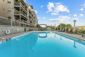 A swimming pool with a clear blue water surface, surrounded by a wooden deck with lounge chairs. - Huge Table Rock Lake Views, Sleeps 5- Close to SDC (Branson)