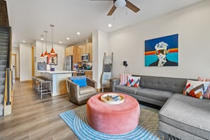 A modern living space with a kitchen, dining area, and seating area. - Winter Park Escape -Luxury, Hot Tub, Pet Friendly (Winter Park)