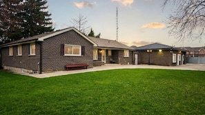 A two-story building with a brick facade, a covered patio area, and a well-maintained lawn. - Brand New - Private Renovated Estate - Secluded! (Brampton)