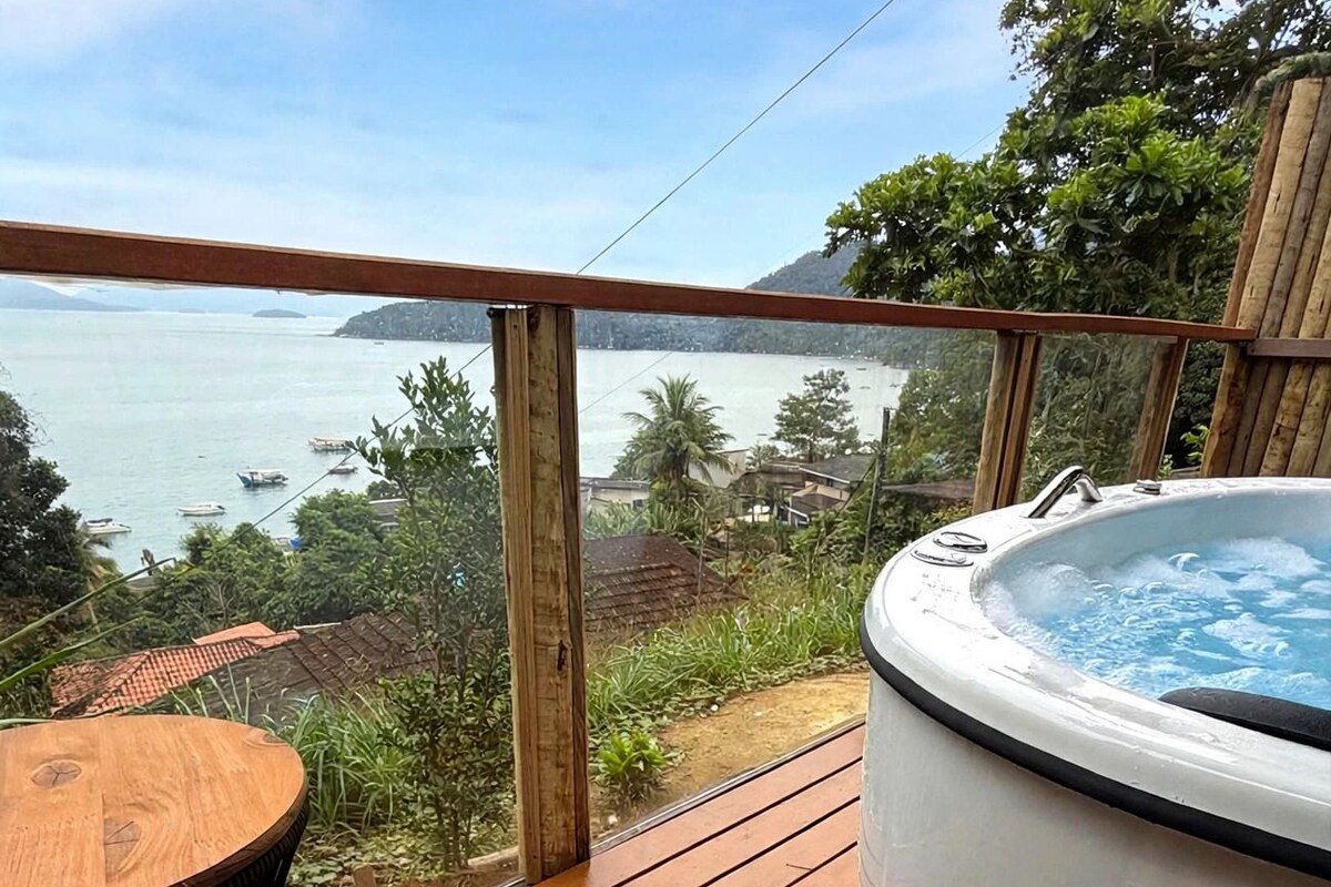 A wooden deck with a hot tub, a table, and a chair.