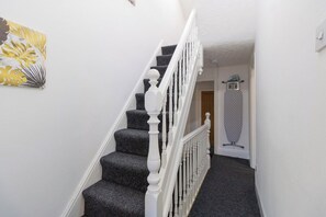 A staircase with a white balustrade leading to a landing. - Spacious Central House | Parking | Old Trafford (Stretford)