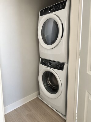 A corner laundry room with two stacked washing machines. - Luxury 1-bedroom apartment in fantastic King of Prussia (King of Prussia)