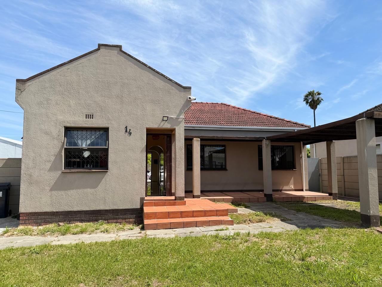 A single-story house with a flat roof, a front door, and a small porch.