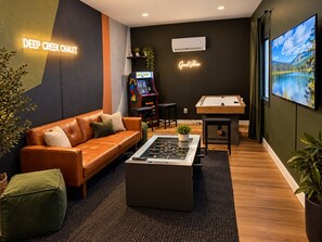 Un espace de détente moderne comprenant une table de baby-foot, un canapé et une table de billard.