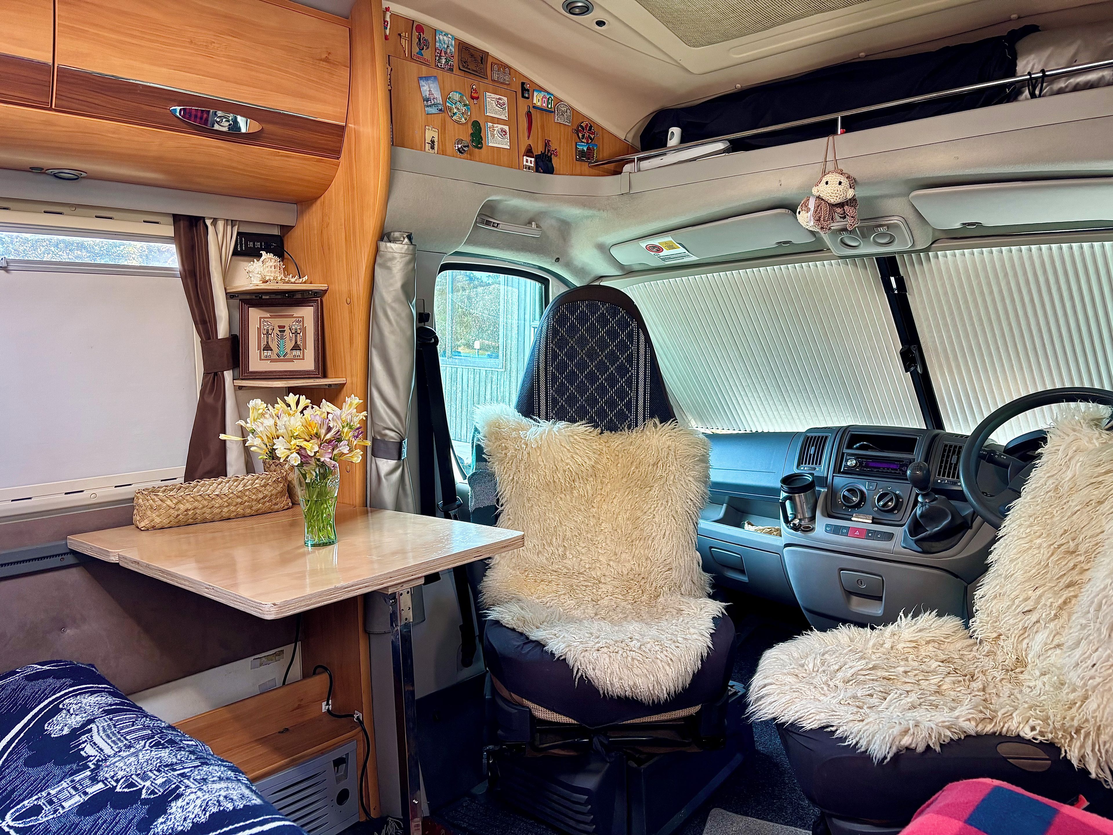 A cozy interior with a table, chairs, and a window.