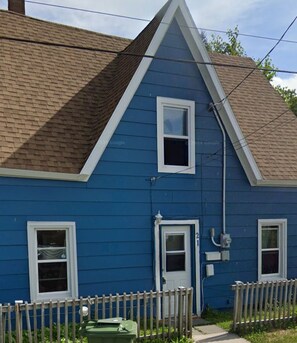 A two-story house with a blue exterior, a wooden picket fence, and a front door. - Home in North Sydney near ferry (North Sydney)