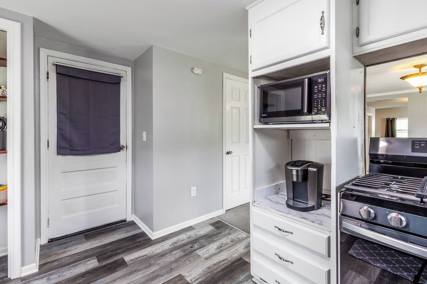 Bright updated kitchen with coffee station and stainless gas range